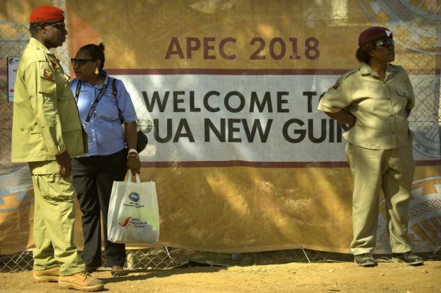 Security officers in front of Apec sign in Papua New Guinea