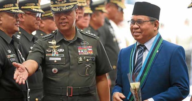 RED CARPET Holding a stem of rose, MILF chair Murad Ebrahim (right) is introduced to top military commanders by AFP chief Gen. Carlito Galvez Jr. at Camp Aguinaldo. —NIÑO JESUS ORBETA