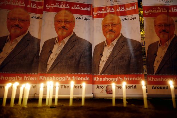 Candles before images of Jamal Khashoggi