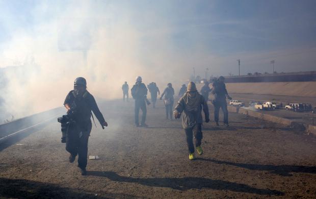 Migrants running from tear gas U.S.-Mexico border
