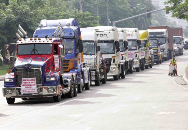NO DELIVERIES Around 30 trucks under the Alliance of Philippine Brokers and Truckers Associations roll out in convoy on Road 10 in Tondo, Manila, on Monday to launch the six-day protest. —Marianne Bermudez