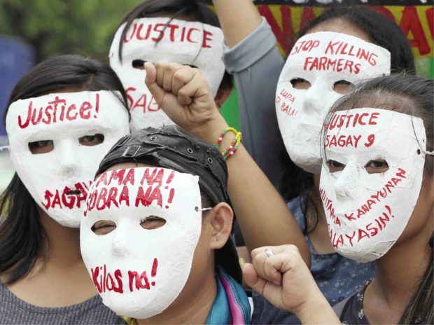 RAGE Activists wear masks during a rally near Malacañang on Nov. 16 blaming the government for a spate of killings of human rights workers, including lawyer Benjamin Ramos Jr. —MARIANNE BERMUDEZ