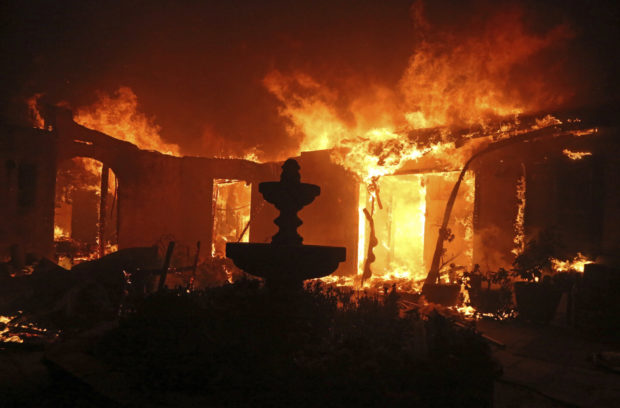 California Wildfires Malibu A Spanish-style home is consumed by flames on Dume Drive in the Point Dume area of Malibu, Calif., Friday, Nov. 9, 2018. Known as the Woolsey Fire, it has consumed tens of thousands of acres and destroyed multiple homes. (AP Photo/Reed Saxon)