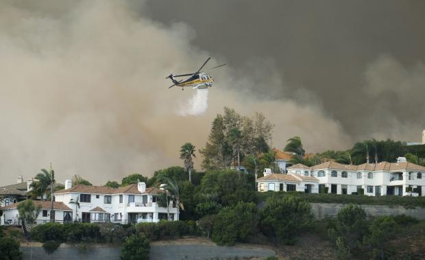 Firefighting chopper over Woolsey houses