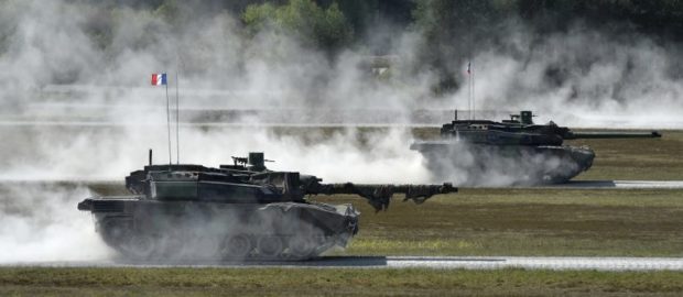 French army tanks type 'Leclerc' drive during a first shooting of the exercise 'Strong Europe Tank Challenge 2017' at the exercise area in Grafenwoehr, near Eschenbach, southern Germany, on May 11, 2017. - Platoons from NATO nations France, Germany, USA and their partners Austria and Ukraine take part in this exercise. (Photo by Christof STACHE / AFP)