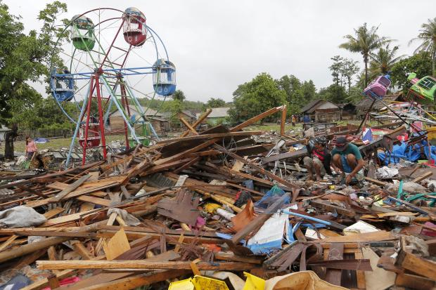 People sifting through tsunamis debris in Indonesia