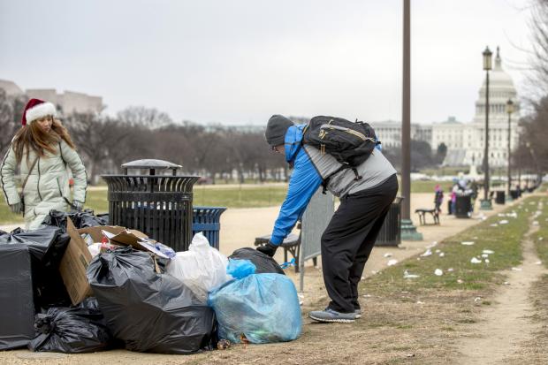  Man picks up garbage at National Mall