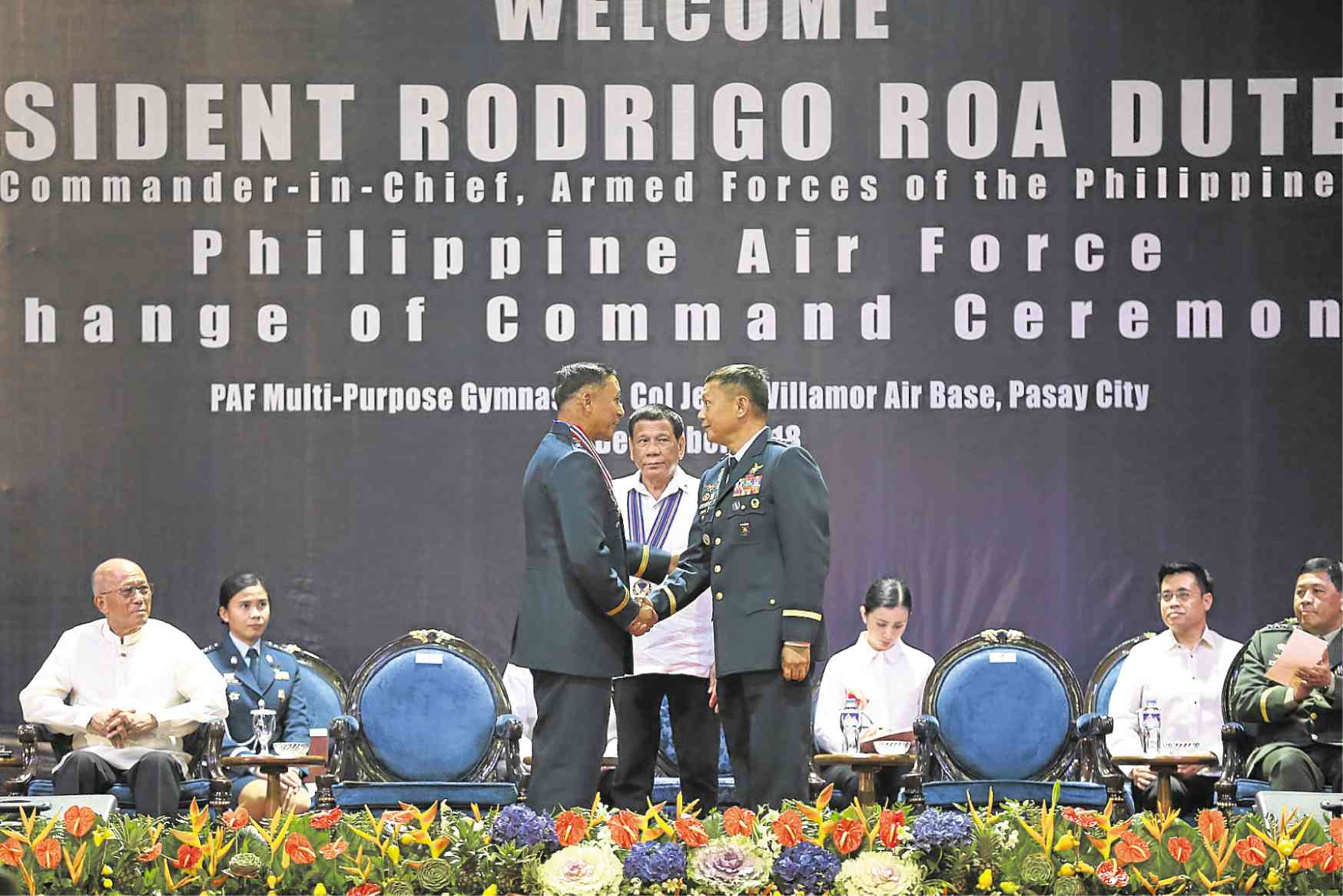 CHANGE OF COMMAND President Duterte witnesses the turnover of leadership of the Philippine Air Force from outgoing Lt. Gen. Galileo Gerard Kintanar (left) to Lt. Gen. Rozzano Briguez during a program at Villamor Air Base in Pasay City on Friday. —JOAN BONDOC