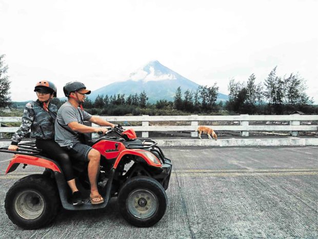 TOP ATTRACTION Activities in areas around Mt. Mayon, Bicol region’s top attraction, continue even as the Philippines’ most active volcano spews out ash on Thursday. GEORGE GIO BRONDIAL