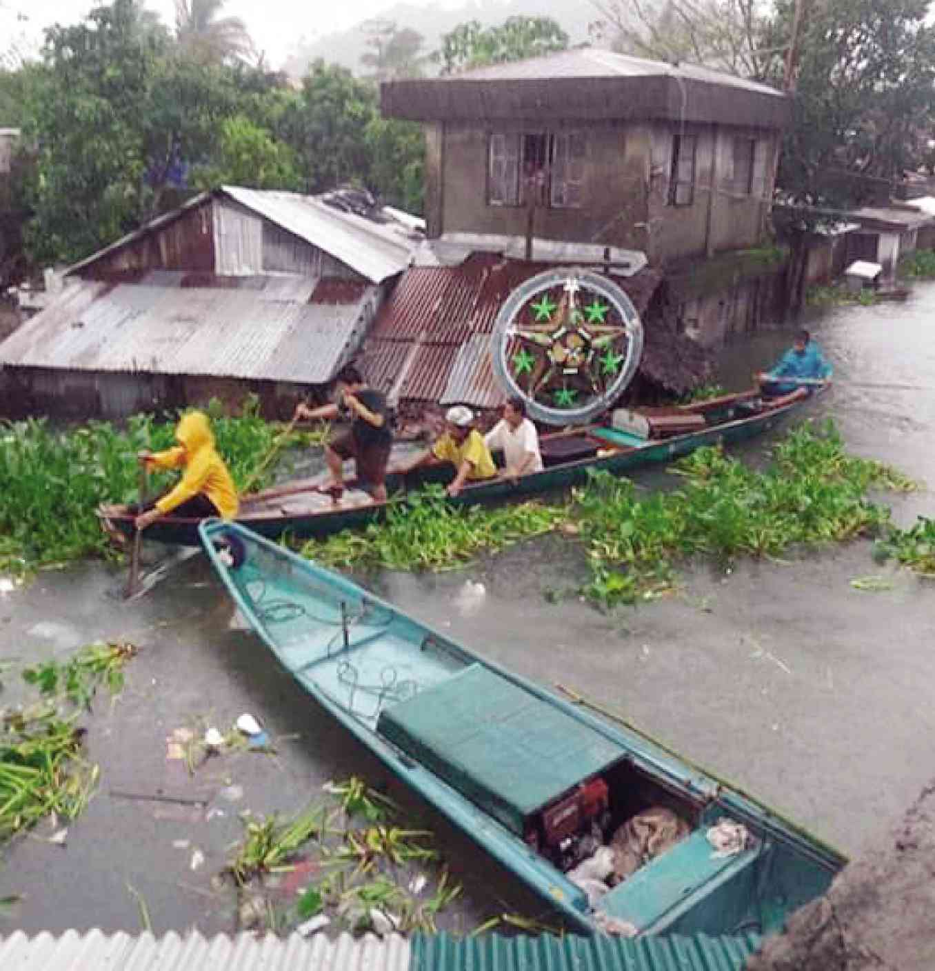 HOLIDAY TURNS TO HARDSHIP The people of Buhi, Camarines Sur, including residents who have adorned their homes with a Christmas star, may find little reason to celebrate on New Year’s Eve after rains dumped by Tropical Depression “Usman” left the town submerged in floodwaters. PHOTO COURTESY OF BUHI POLICE