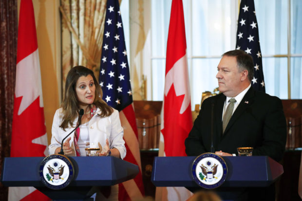 Canadian Minister of Foreign Affairs Chrystia Freeland, left, with Secretary of State Mike Pompeo, speaks to reporters during a news conference at the State Department in Washington, Friday, Dec. 14, 2018. (AP Photo/Manuel Balce Ceneta)