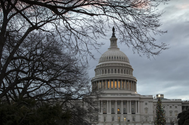 The Capitol is seen on the first morning of a partial government shutdown, as Democratic and Republican lawmakers are at a standoff with President Donald Trump on spending for his border wall, in Washington, Saturday, Dec. 22, 2018. A partial federal shutdown took hold early Saturday after Democrats refused to meet President Donald Trump's demands for $5 billion to start erecting a wall with Mexico. (AP Photo/J. Scott Applewhite)