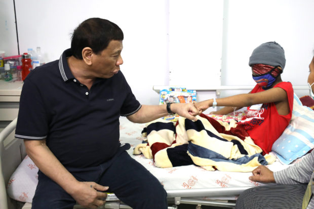 President Rodrigo Roa Duterte does the fist bump with one of the pediatric cancer patients during his visit at the Southern Philippines Medical Center's Cancer Institute Children's Unit in Davao City on December 23, 2018. TOTO LOZANO/PRESIDENTIAL PHOTO