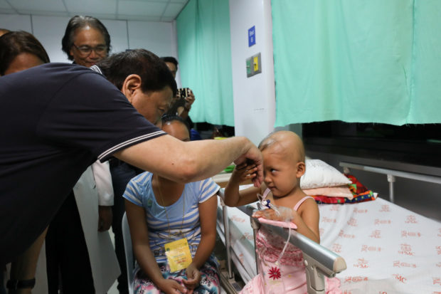 President Rodrigo Roa Duterte blesses a pediatric patient during his visit at the Southern Philippines Medical Center's Cancer Institute Children's Unit in Davao City on December 23, 2018. TOTO LOZANO/PRESIDENTIAL PHOTO