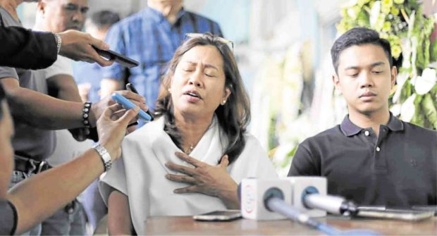 FAMILY’S GRIEF Gertrudes Duran-Batocabe, widow of slain Ako Bicol Rep. Rodel Batocabe, and their son Justin are interviewed by reporters on the Bicol University Daraga campus in Albay.