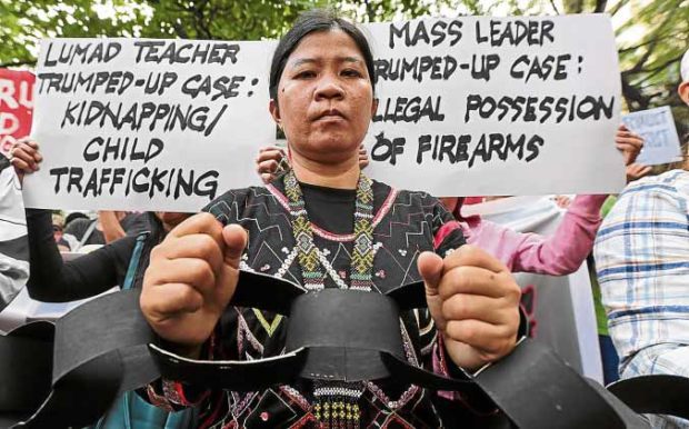 CHAINED BY MILITARY RULE A lumad protester wears props designed as chains at a rally on Dec. 6 in front of the Department of Justice to protest martial law in Mindanao. —GRIG C. MONTEGRANDE