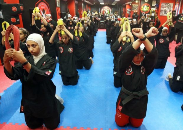 Kuwaiti women practise hybrid martial art Kajukenbo in a club in Kuwait City on October 22, 2018. - Kajukenbo was born in Hawaii in the 1940s. The sport's name was derived from the various aspects of martial arts it includes: karate (KA), judo and jujitsu (JU), kenpo (KEN) and boxing (BO). (Photo by Yasser Al-Zayyat / AFP) kuwait