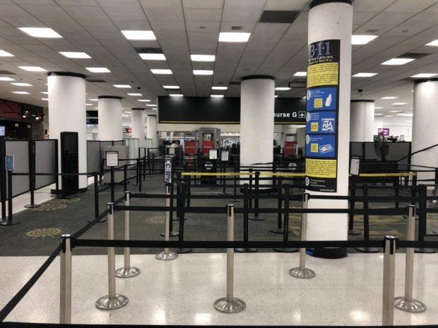 This image shows the deserted Terminal G security check point area of the Miami International Airport on January 12, 2018 after it was forced to shut down due to a shortage of security agents sparked by the partial US government shutdown now in its 22nd day. - For three days, from Saturday, January 19th,  through Monday, January 14th, Terminal G -- one of six at the airport -- will be closed. (Photo by Gianrigo MARLETTA / AFP)