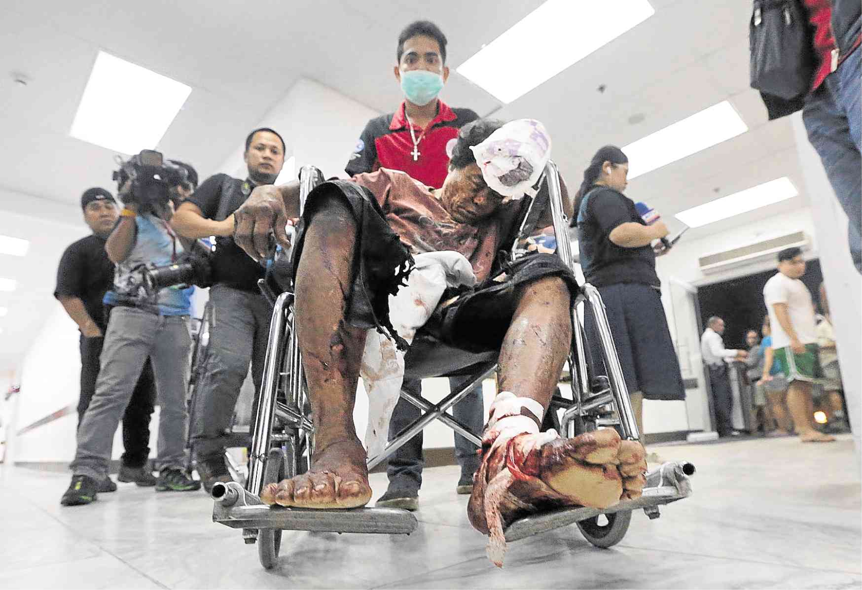NO LESSON LEARNED Emergency staffers of Jose Reyes Memorial Medical Center wheel in a man with firecracker injuries minutes after the country welcomed the New Year. —GRIG C. MONTEGRANDE