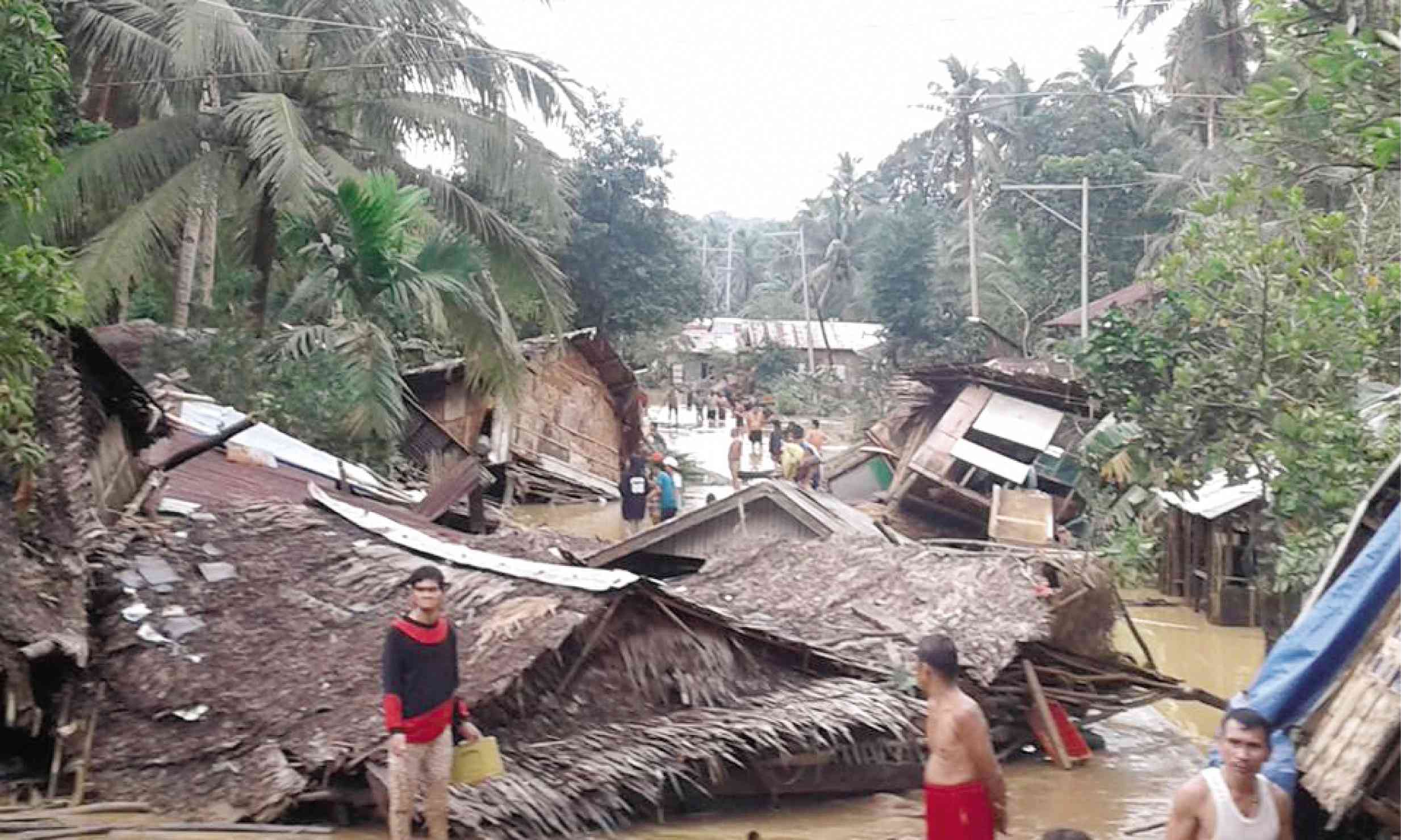 REBUILDING Residents of Lope de Vega, Northern Samar, have no time to celebrate New Year as they start to rebuild their houses after floods, triggered by heavy rains dumped by Tropical Depression “Usman,” hit their town. —CONTRIBUTED PHOTO