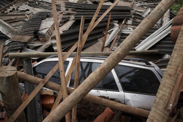 Car covered in debris after dam collapse in Brazil