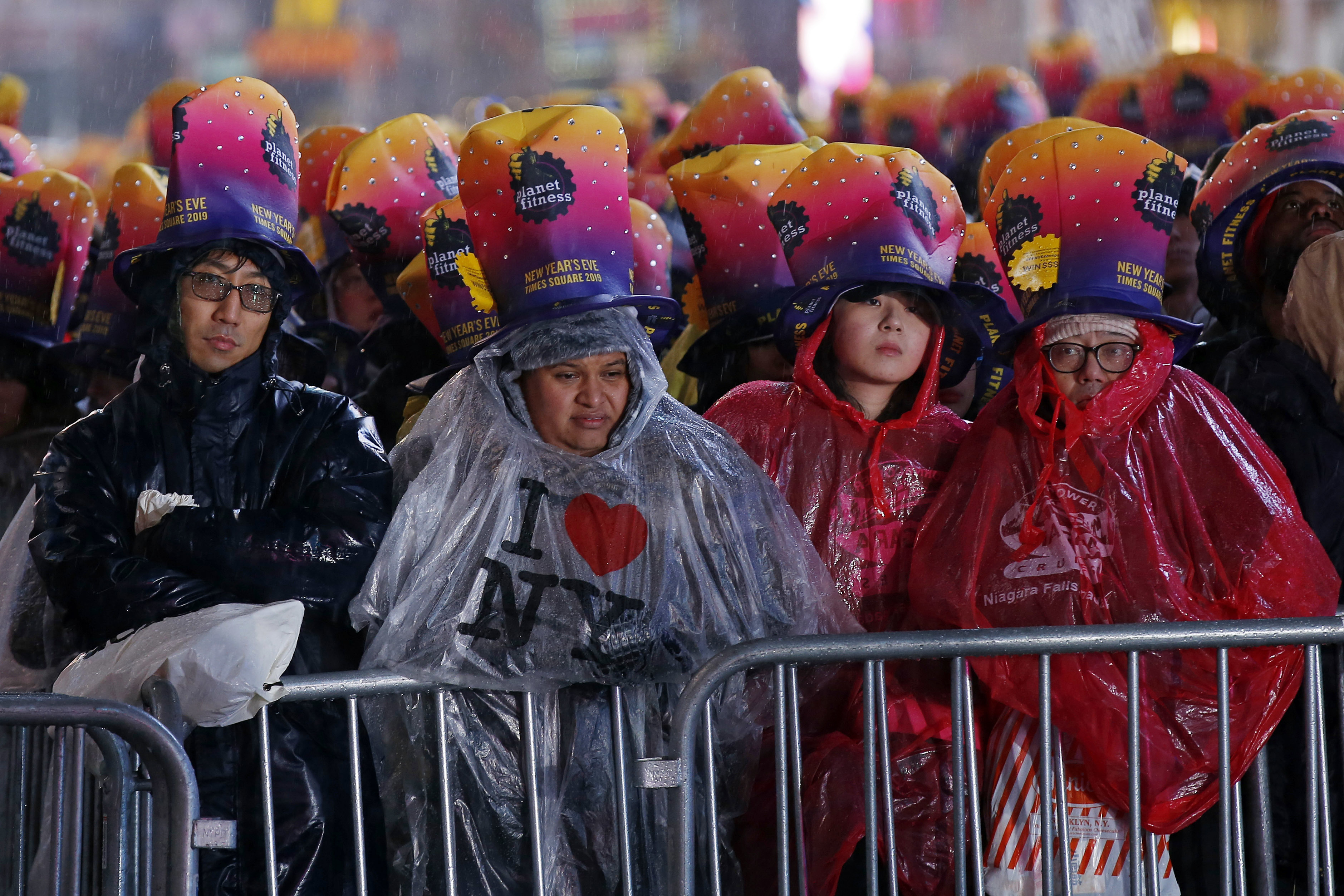 Times Square crowd braves rain to bid wet goodbye to 2018