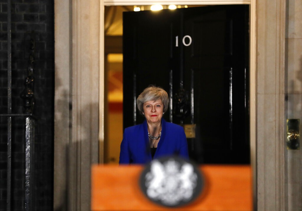 May battles to keep Brexit on track after no-confidence win