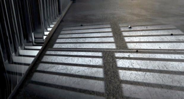 Prison bars casting shadow on floor