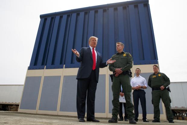 Donald Trump inspecting wall prototypes