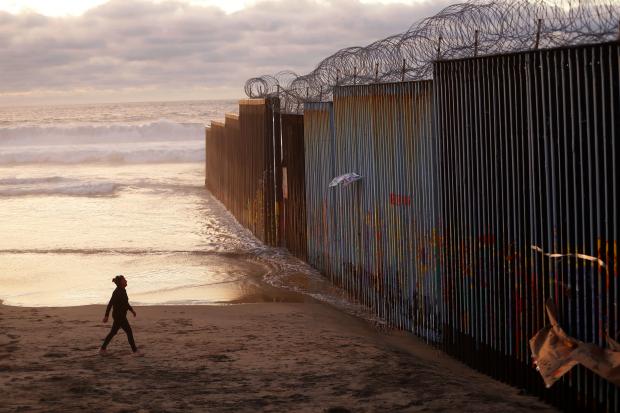 Woman at US border wall