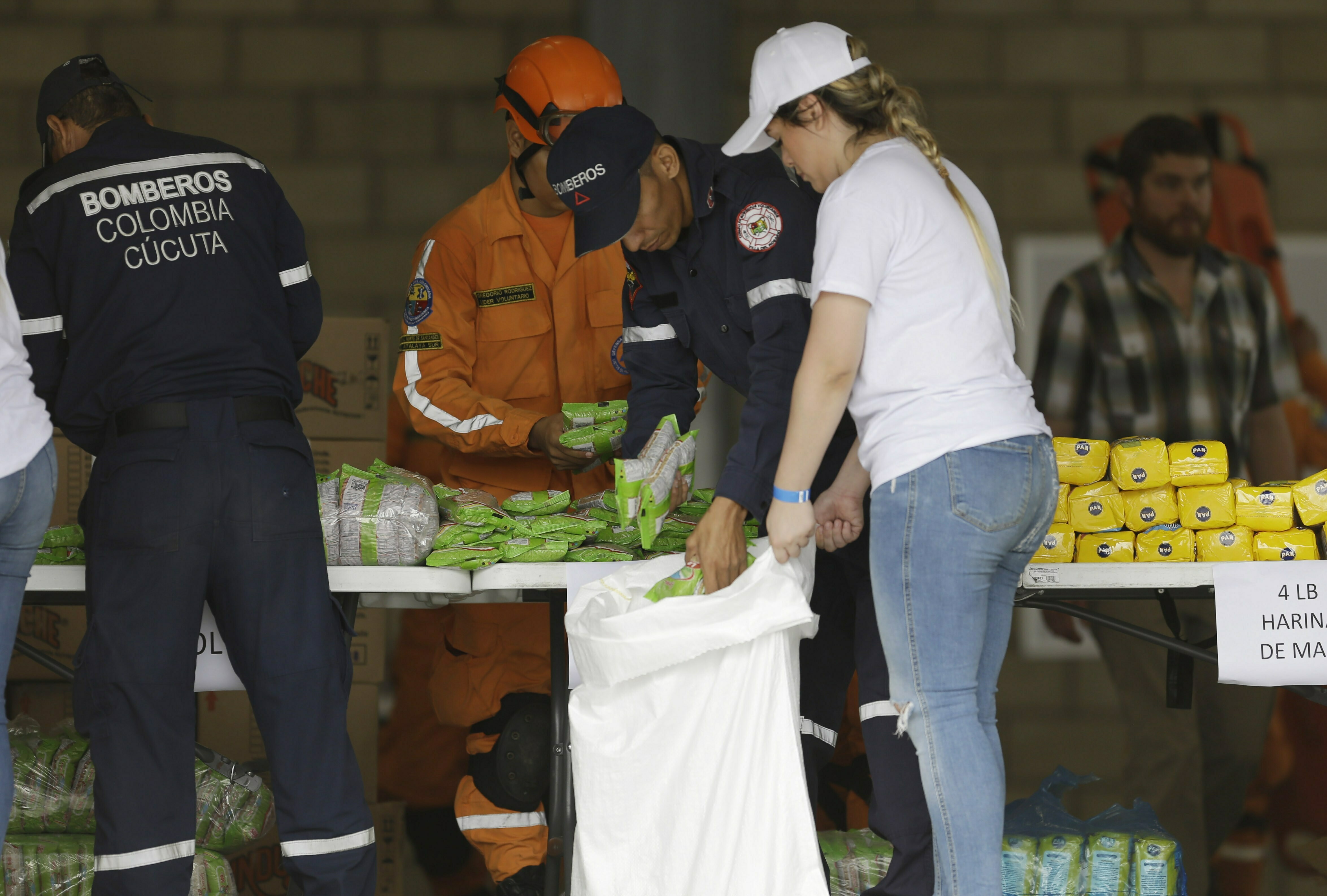 Volunteers ready US aid set for Venezuela as Maduro digs in