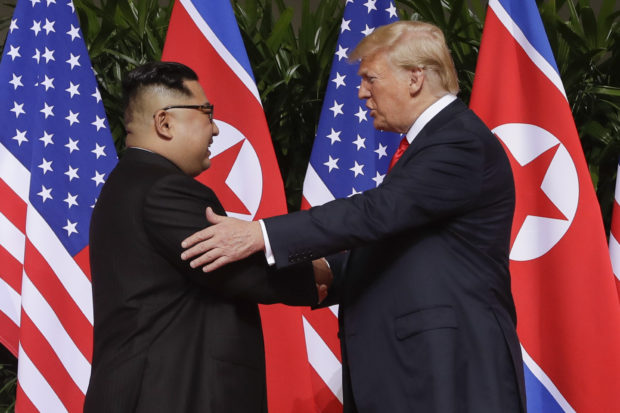 FILE - In this June 12, 2018 file photo, President Donald Trump shakes hands with North Korea leader Kim Jong Un at the Capella resort on Sentosa Island in Singapore. As he prepares to meet again North Korea's Kim Jong Un, President Donald Trump is replaying many of the same moves, with a suspenseful buildup, make-or-break stakes and dramatic rendezvous in a far-flung locale. But the reality-star president is about to learn if the sequel can compete with the original. (AP Photo/Evan Vucci, File)