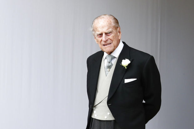 FILE - In this Friday, Oct. 12, 2018 file photo, Britain's Prince Philip waits for the bridal procession following the wedding of Princess Eugenie of York and Jack Brooksbank in St George's Chapel, Windsor Castle, near London, England. Buckingham Palace said Saturday Feb. 9, 2019, that 97-year-old Prince Philip has decided to stop driving, less than a month after he was involved in a collision that left two women injured. (AP Photo/Alastair Grant, Pool, File)