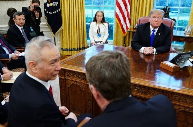 US President Donald Trump watches as China's Vice Premier Liu He (L) speaks with US Trade Representative Robert Lighthizer (R) in the Oval Office of the White House in Washington, DC on February 22, 2019. - Just a week remains to avoid a sharp increase in US duty rates on more than $200 billion in Chinese exports -- though Trump has suggested he could extend the March 1 deadline. (Photo by MANDEL NGAN / AFP)