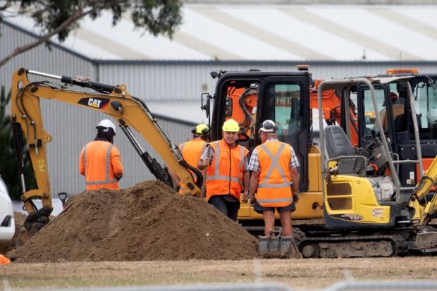 Workers dig grave sites at a cemetery in Christchurch on March 17, 2019 two days after a shooting incident at two mosques in the city. - New Zealanders flocked to memorial sites to lay flowers and mourn the victims of the twin mosque massacres on March 17, as testimony emerged of epic heroism and harrowing suffering in the gun attack that has claimed 50 lives. (Photo by Marty MELVILLE / AFP)