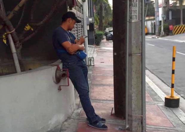 Man on street using cellphone