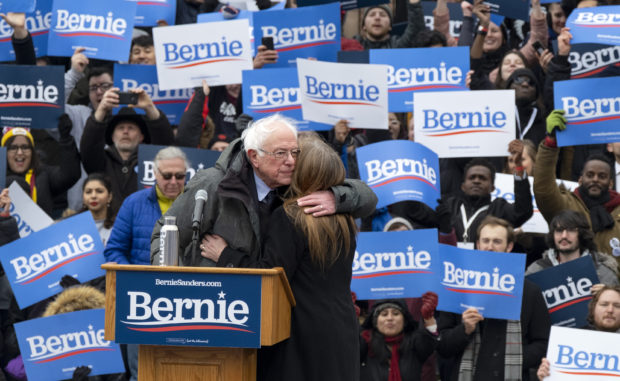 Sen. Bernie Sanders, I-Vt., hugs his wife Jane after he finished speaking  Saturday, March 2, 2019, in the Brooklyn borough of New York.  Sanders returned to Brooklyn, his birthplace, for the first rally of his second presidential campaign and sought to tie his working-class background to his populist views that are helping reshape the Democratic Party. (AP Photo/Craig Ruttle)