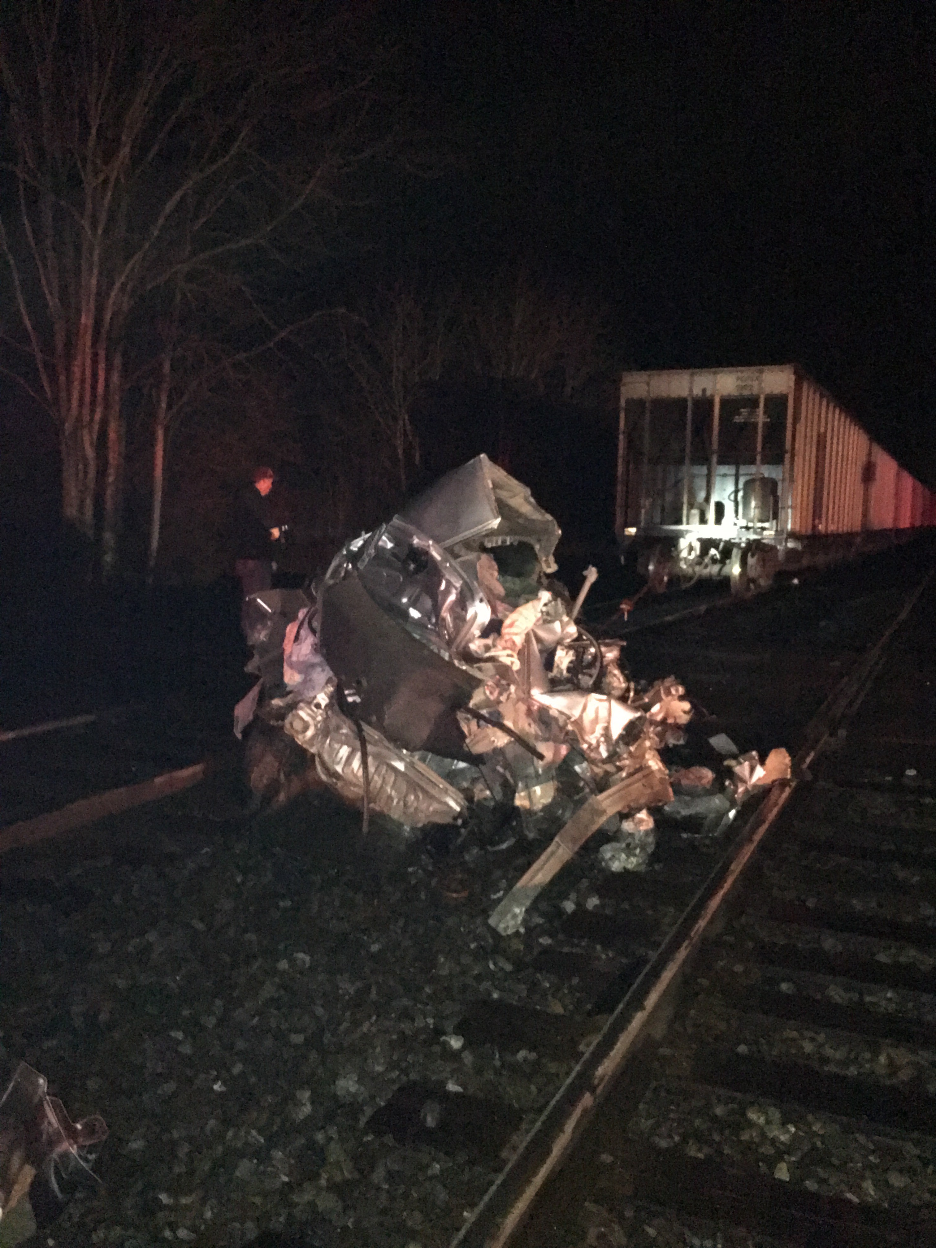 4 escape car hit by 2 trains going opposite ways