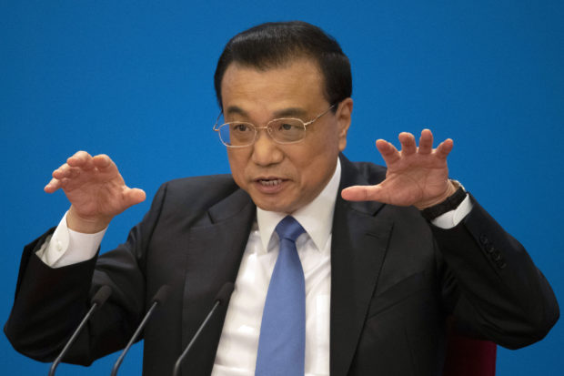 China's premier denies Beijing tells companies to spy