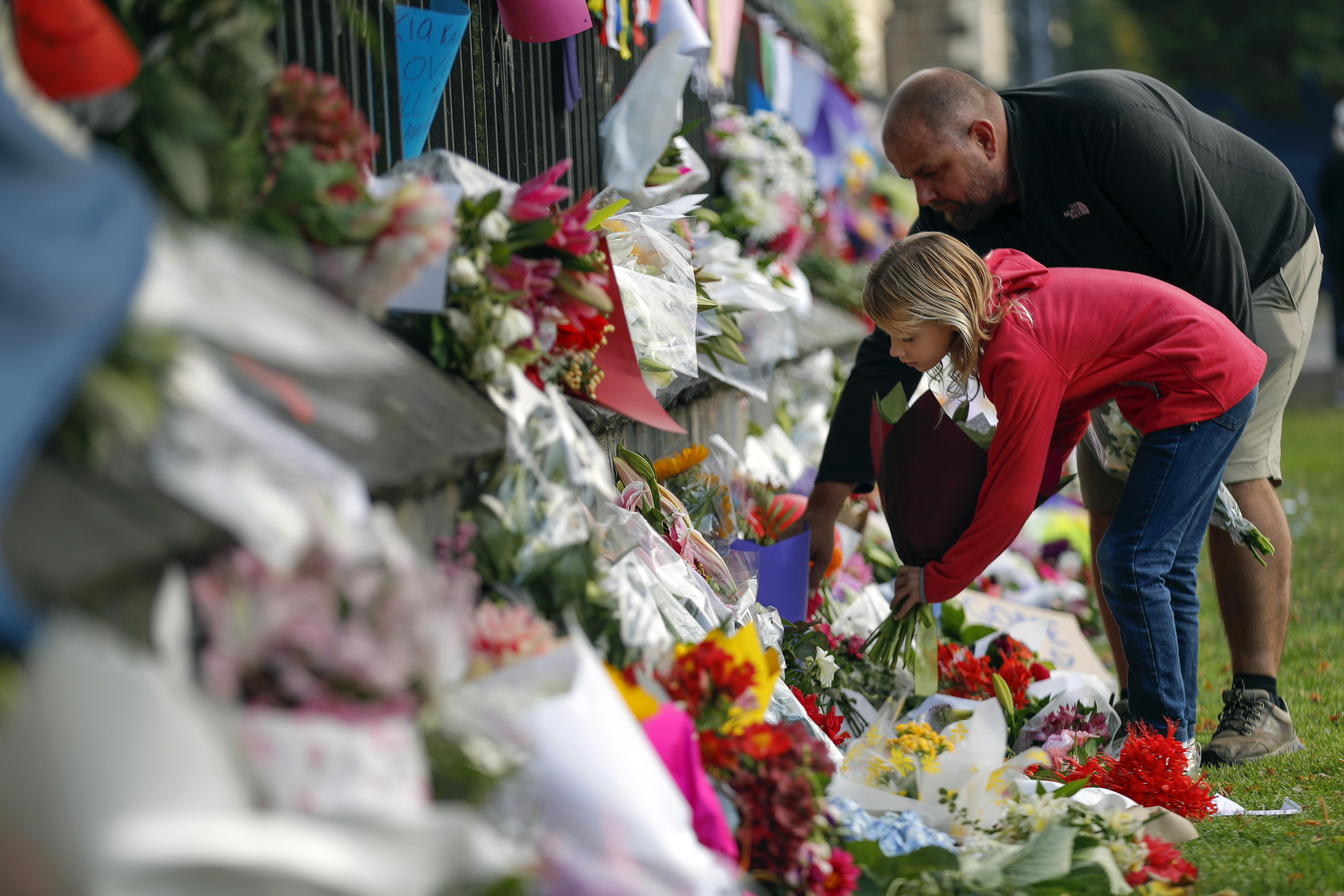 Mourners pay tribute to New Zealand victims, await burials