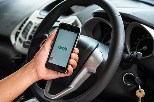 Cellphone showing Grab logo in car