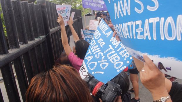 LOOK: Progressive groups storm Manila Water office