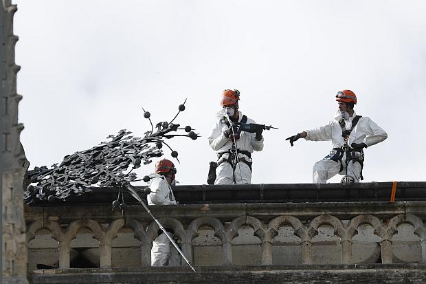 Construction workers on top of Notre Dame Cathedral