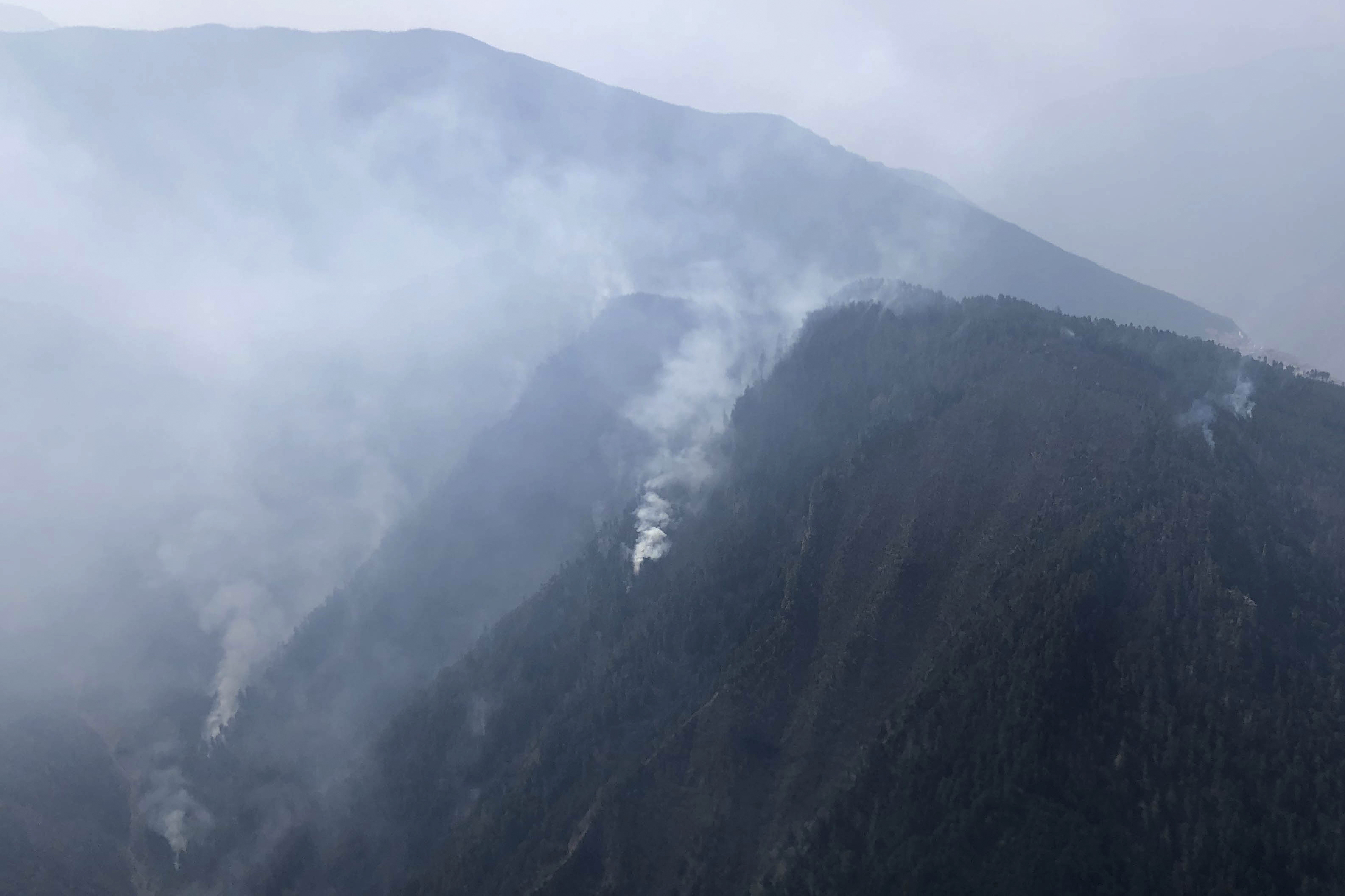 Firefighters contain fire in China's mountains where 30 died