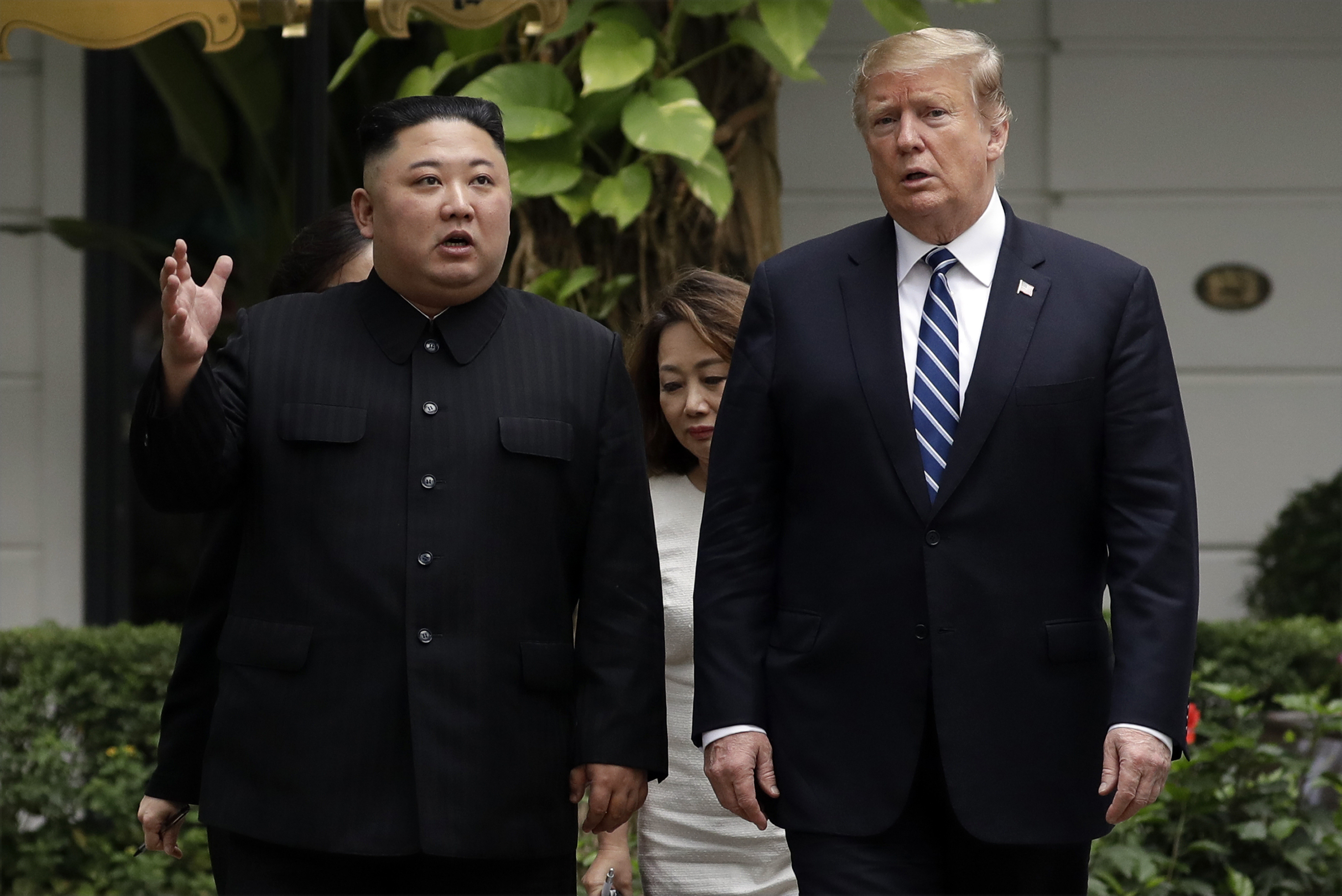 FILE - In this Thursday, Feb. 28, 2019, file photo, President Donald Trump and North Korean leader Kim Jong Un take a walk after their first meeting at the Sofitel Legend Metropole Hanoi hotel, in Hanoi. Kim says he’s open to having a third summit with Trump if the United States could offer mutually-acceptable terms for an agreement by the end of the year. (AP Photo/Evan Vucci, File)