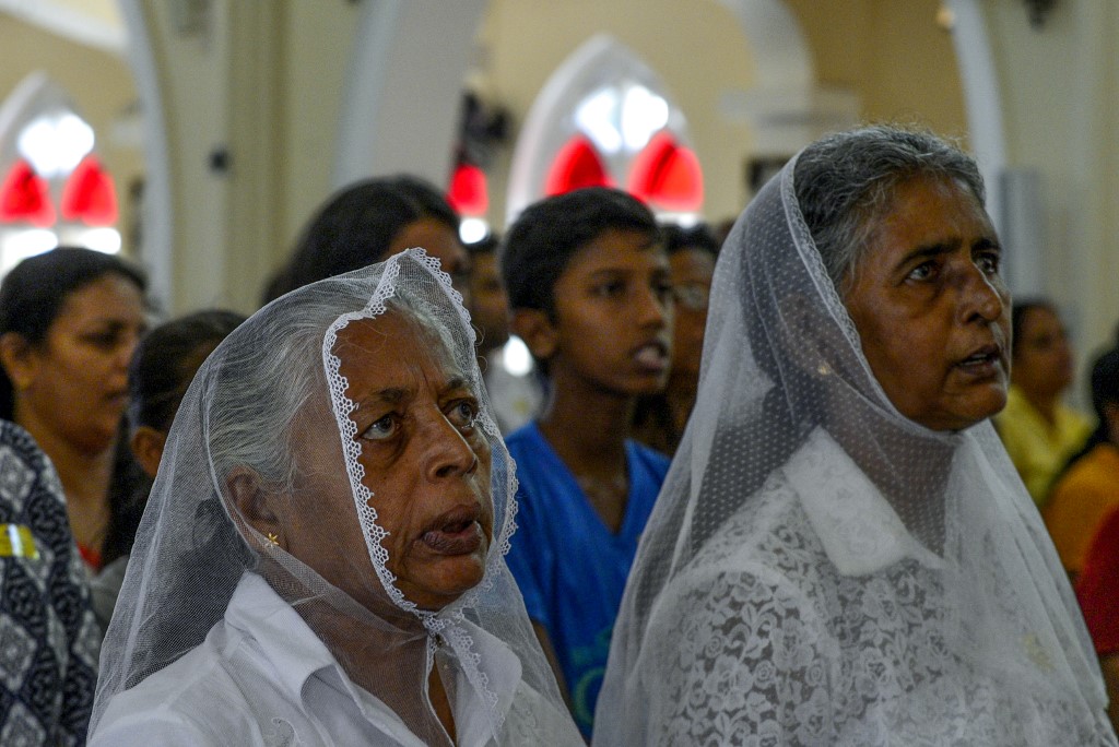 Sri Lankan Catholic devotees pray during a mass at the St. Theresa's church as the Catholic churches hold services again after the Easter attacks in Colombo on May 12, 2019. - Thousands of Catholics attended mass in Sri Lanka's capital Colombo on May 12 amid tight security to prevent a repeat of Easter bomb attacks that killed 258 people. (Photo by LAKRUWAN WANNIARACHCHI / AFP) sri lanka