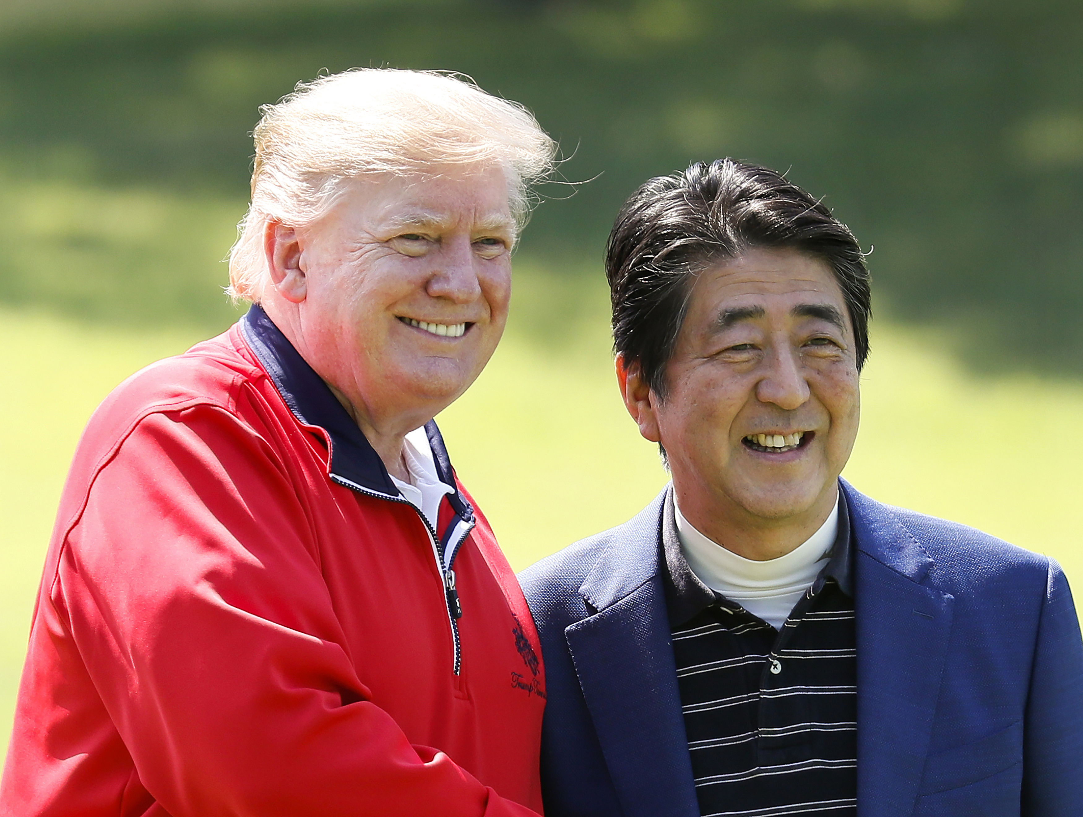 U.S. President Donald Trump, left, and Japanese Prime Minister Shinzo Abe smile before playing a round of golf at Mobara Country Club in Mobara, south of Tokyo, Sunday, May 26, 2019. (Kimimasa Mayama/Pool Photo via AP)