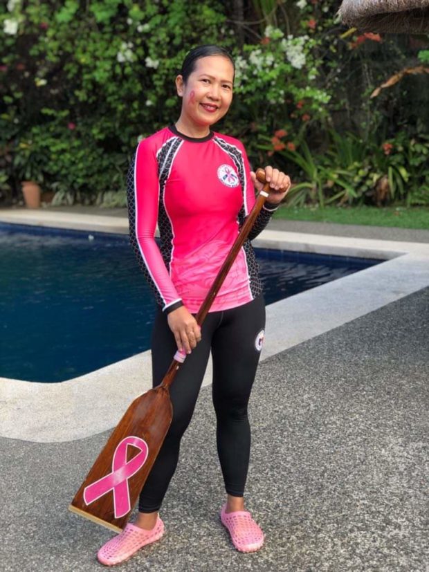 Breast cancer survivor paddles for gold as dragon boat member