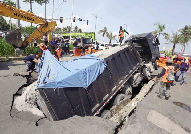 Overloaded truck causes part of road to collapse