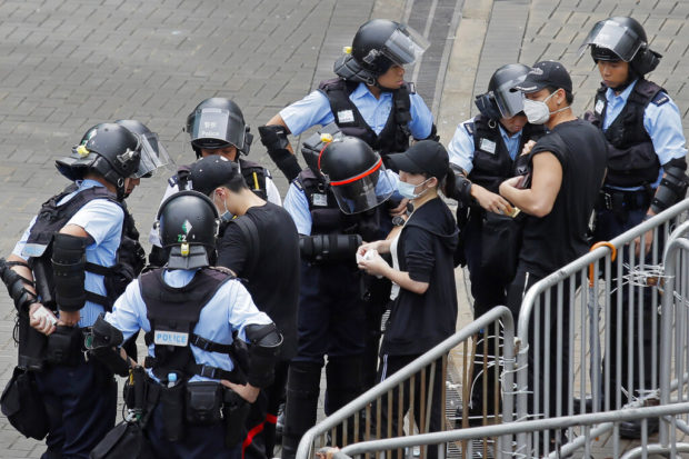 Hong Kong protesters sing hymns, slam violence